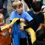 Kids get their hands on a python at the Reptile Man section of Circus. Andy Nystrom/ staff photo