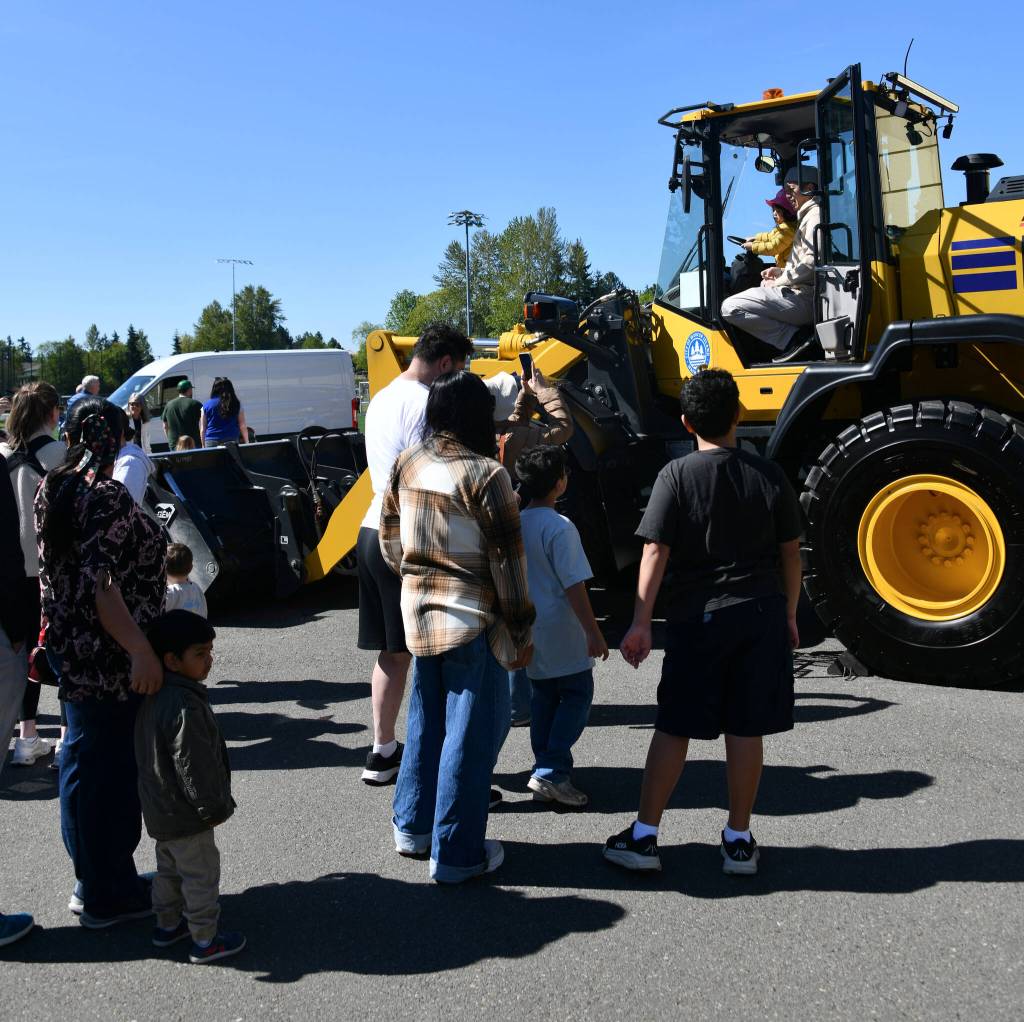 Circus attendees climb on a tractor outside at Islander Middle School. Andy Nystrom/ staff photo