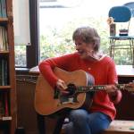 Stewart plays the guitar between books at storytime. The guitar gives Stewart the opportunity to sing songs like The Wheels on the Bus and Down by the Bay. Photo by Addie Stoterau