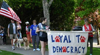 Mercer Island residents participate in the Dogs for Democracy event on May 9 at Mercerdale Park. The group walked through the park and the nearby business district. The event was the brainchild and labor of love of Regina Feinberg. Democracy works best when everyone shows up and every bark counts, reads a press release. Andy Nystrom/ staff photo