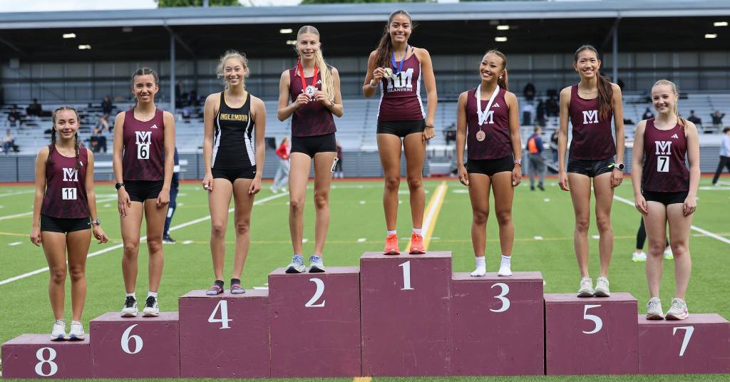 Mercer Island High Schools girls runners took seven of the top eight spots in the 3,200 run at the 3A KingCo championships. They are, from left to right: Tess Ahrenholz, Anna Ahrenholz, Bella Heczey, Sophia Rodriguez (first place), Ella Zhang, Dora Cheng and Elsa Bergman. Also pictured is Inglemoors Lola Estrada. Photo courtesy of Scott Knoblich