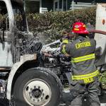 A firefighter extinguishes a truck fire on May 27 on Mercer Island. Photo courtesy of Kris Sundberg