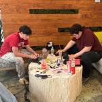 Northwest Yeshiva High School SmartFit designers Levi Schiffman and Daniel Galili put the last-minute touches to their project and presentation before the competition. Courtesy photo