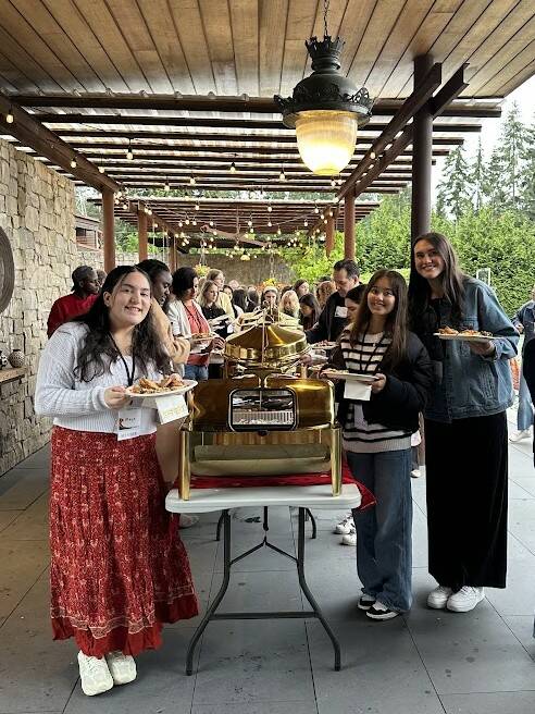 PETRI members Maya Talby, Sarah Kamolz and Sophia Kinkead hold their plates of food provided by Tamu Catering. Photo courtesy of Kim Kamolz