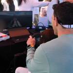 Summer Celebration attendees engage in a hydroplane racing simulator. Andy Nystrom/ staff photo