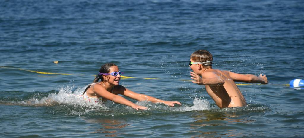 Bellevue resident Nicole Graceys children play Marco Polo during the 90-degree heat in Lake Washington off Luther Burbank Park on July 21. Also pictured are a pair of paddleboarders that same afternoon. Andy Nystrom/ staff photos