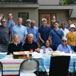 National Night Out party host Kristy Glaze (bottom left) joins her neighbors on her front lawn on Aug. 4 in the 2200 block of 70th Avenue Southeast. Andy Nystrom/ staff photo
