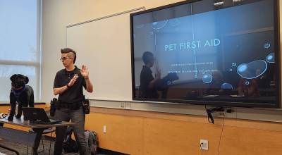 Mercer Island Police Department support officer Andrea Scinkovec teaches a pet first aid course along with assistant Smudge the stuffed Labrador. Courtesy photo